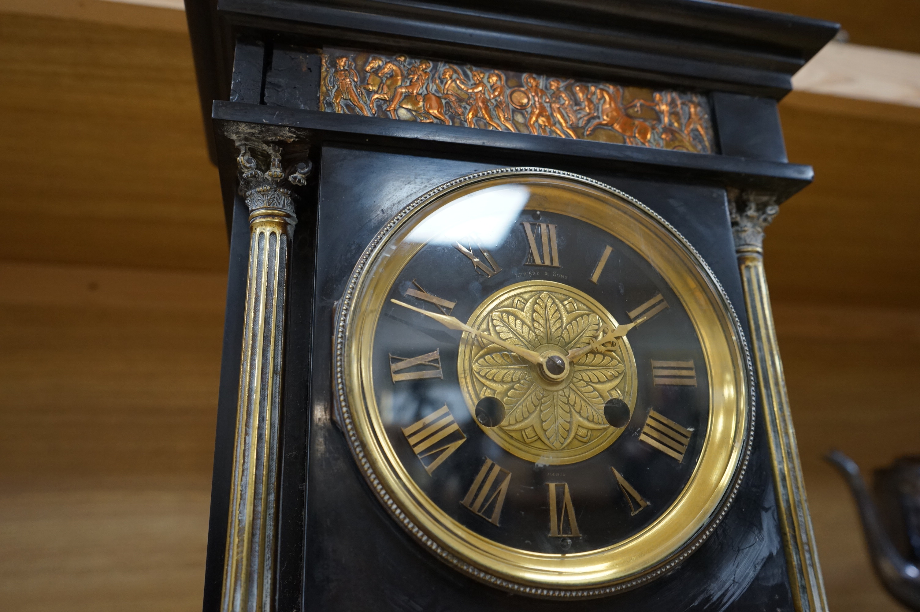 A Victorian slate clock, with copper embossed figural panel, 37cm high. Condition - unknown if working, case good